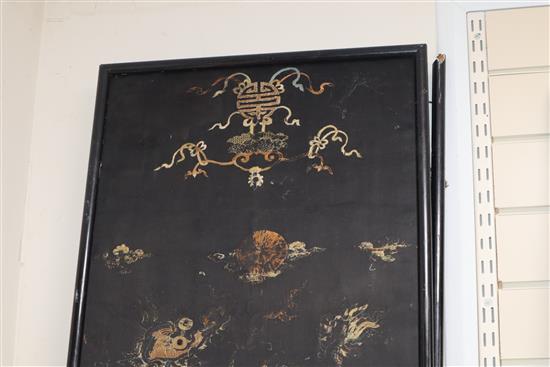 A pair of Chinese/Tibetan embroidered black satin qilin panels, late 19th/early 20th century, 144 x 44cm, worn